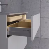 Large bathroom inspiration in Nordic style with bathroom furniture in light blue colour and wooden countertop with elegant countertop basin, herringbone wooden floor creating a bright and classic style