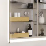 Small bathroom inspiration with a washbasin cabinet in a special color, mirror cabinet with lights, decorative mirrors with tinted glass shelf, white herringbone tiles give a sleek and classic look.