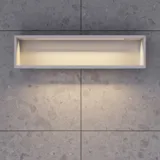 Stylish and spacious bathroom inspiration with a large round mirror with a black frame, dark stone sink, colored toilet, upper cabinet, and open shelf in a sophisticated and muted design