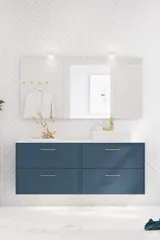 Bathroom inspiration with bathroom furniture in modern blue colour, elegant countertop basin and large square mirror with light, white herringbone tiles create a stylish and classic look