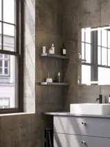 Bathroom inspiration with sloped walls inspiration, grey vanity unit and upper cabinet, custom-made countertops, modern square countertop basin, square mirror with lights, raw concrete walls and floors create an urban look