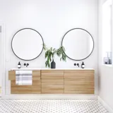 Nordic bathroom in wood finish with beautiful black framed round mirrors and plenty of storage in the furniture