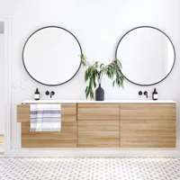 Nordic bathroom in wood finish with beautiful black framed round mirrors and plenty of storage in the furniture