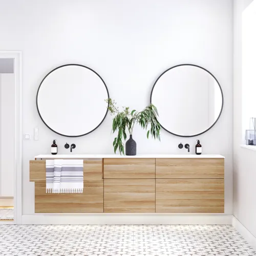 Nordic bathroom in wood finish with beautiful black framed round mirrors and plenty of storage in the furniture