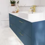 Bathroom inspiration with bathroom furniture in modern blue colour, elegant countertop basin and large square mirror with light, white herringbone tiles create a stylish and classic look