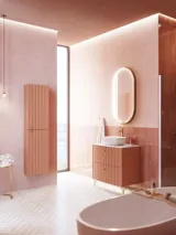 Large vintage retro bathroom inspiration with a terracotta-colored grooved vanity, elegant thin countertop with a beautiful vessel sink, stylish oval mirror with brass edge. Pink tiles and grey herringbone tiles give a romantic and feminine look