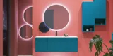 Large bathroom inspiration with blue special color grooved furniture, thin elegant sink, and beautiful round mirrors, red walls, and terrazzo floor create a strong contrast to the furniture, giving a stylish and urban look.