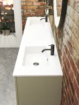 Raw and modern bathroom in an urban style. Beautiful vanity units and black framed round mirrors