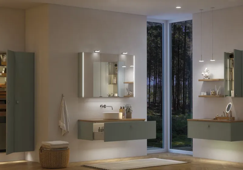 Large bathroom inspiration in Nordic style with bathroom furniture in light blue colour and wooden countertop with elegant countertop basin, herringbone wooden floor creating a bright and classic style