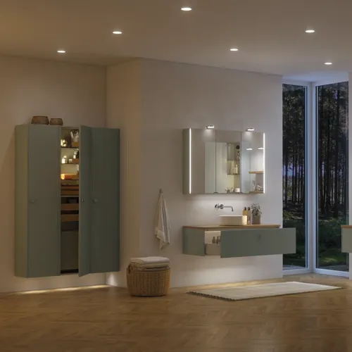 Large bathroom inspiration in Nordic style with bathroom furniture in light blue colour and wooden countertop with elegant countertop basin, herringbone wooden floor creating a bright and classic style