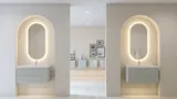 Stylish and modern bathroom inspiration with oval mirrors with light control, stone sinks, and vanity units with fine and elegant grooves in a minimalist design, the bathroom has a light and airy atmosphere with elegant lighting and refined details
