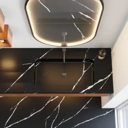 Modern and stylish bathroom inspiration with an oval mirror with a black frame and light control, colored toilet, vanity unit, base cabinets, and cabinets in reddish-brown oak, Silestone sink and matching floor
