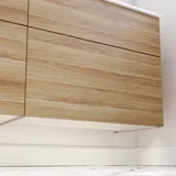 Nordic bathroom in wood finish with beautiful black framed round mirrors and plenty of storage in the furniture