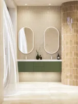 Large and luxurious bathroom with lovely oval mirrors and beautiful tiles in natural colours