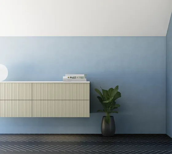 Bathroom with slanted ceiling inspiration, beige furniture with grooves, elegant countertop and square sink, beautiful mirror with shelves, blue walls, large windows, and black herringbone floor give a bright, urban look.