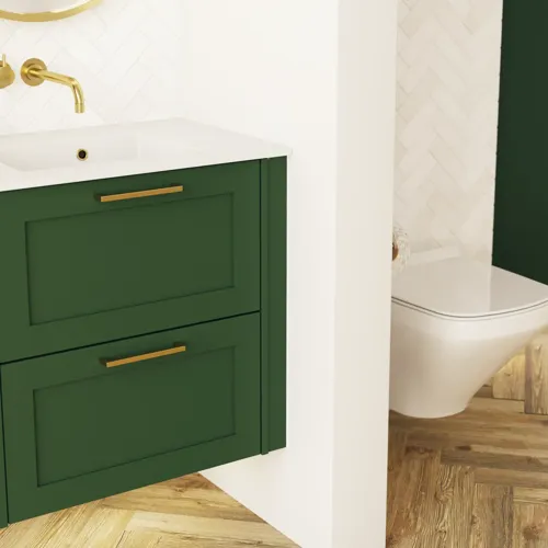 Large bathroom in green colors with vanity unit, brass framed oval mirror and beautiful framed doors