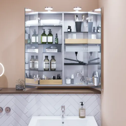 Small bathroom inspiration with a washbasin cabinet in a special color, mirror cabinet with lights, decorative mirrors with tinted glass shelf, white herringbone tiles give a sleek and classic look.