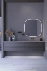 Large bathroom inspiration with grey vanity unit with integrated handle, stylish side-mounted sink, square mirror with rounded corners, concrete-look walls and raw materials for an urban look