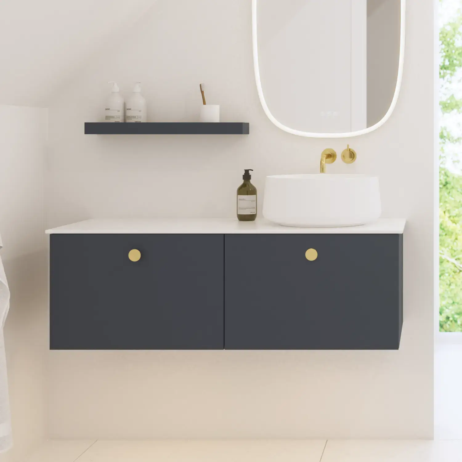 Elegant and modern bathroom inspiration with slanted ceiling, wall-mounted blue vanity unit and base cabinets, round sink with brass faucet, illuminated mirror, and natural light