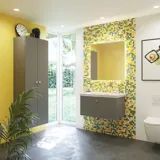 Bathroom inspiration with bathroom furniture in matt grey with elegant washbasin, beautiful square mirror, grey floor and small tiles in different shades of yellow and green, which with yellow wall gives a bright and playful expression