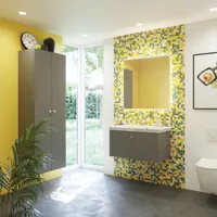Bathroom inspiration with bathroom furniture in matt grey with elegant washbasin, beautiful square mirror, grey floor and small tiles in different shades of yellow and green, which with yellow wall gives a bright and playful expression