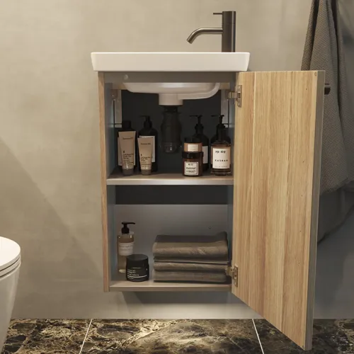 Stylish and minimalist bathroom inspiration featuring a micro basin with a small vanity unit, a square mirror with rounded corners and a lamp, and an elegant mirror cabinet.