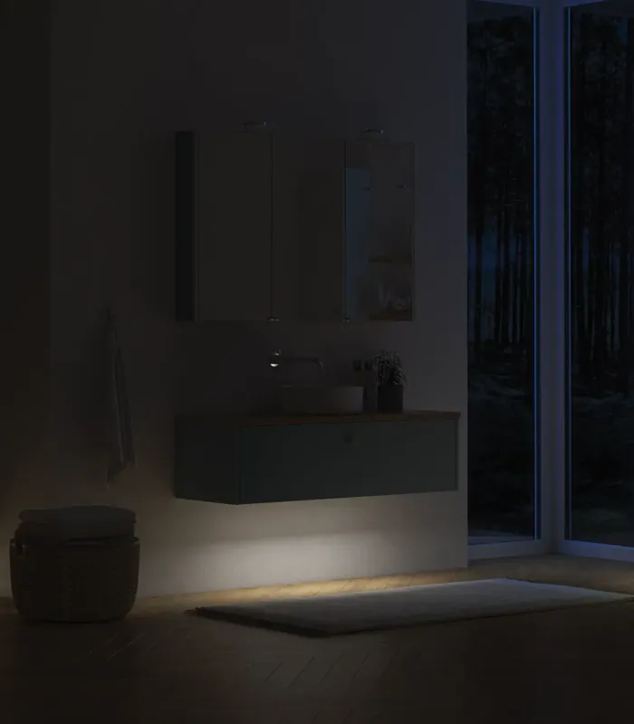 Large bathroom inspiration in Nordic style with bathroom furniture in light blue colour and wooden countertop with elegant countertop basin, herringbone wooden floor creating a bright and classic style