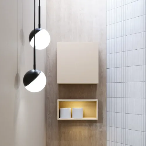 Stylish bathroom inspiration with beige vanity unit with inner drawer, upper cabinet, open shelf, oval mirror with lighting, matching pendants, shelf under the mirror, and wall-mounted toilet. Walls with light, elongated tiles