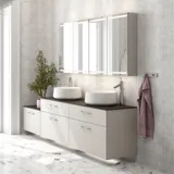 Romantic bathroom inspiration with mirror cabinet offering practical and graceful storage solutions, double countertop sinks on a stone countertop.