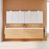 Modern makeup table in Nordic style with light wood, elegant lighting, mirror, and storage shelves, creating a stylish and functional space.