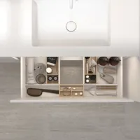 Smart drawer organisation with wooden trays in a sleek bathroom for optimal storage.