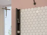 Large bathroom inspiration with white bathroom furniture, square mirror, and shower screen with swing doors with clear glass and profiles in matt black, as well as an elegant electric heated towel rail.