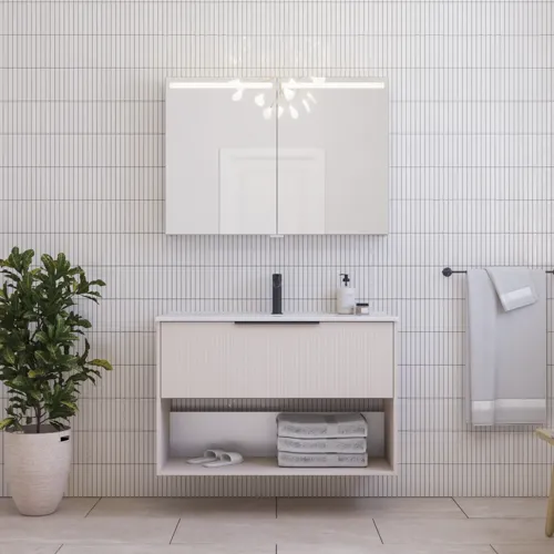 Large bathroom inspiration with small oblong tiles, elegant vanity unit in light beige with beautiful narrow stripes and modern open space, black elongated handles, and stylish mirror cabinet with light to create a romantic atmosphere.