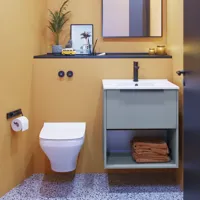 Small bathroom inspiration with slanted and warm yellow walls, elegant light blue vanity unit, thin and sleek sink, and minimalist square mirror with a black edge and practical lamp.