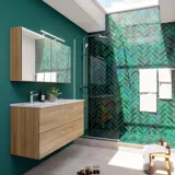 Large bathroom inspiration with a vanity unit in Warm Oak, elegant double sink, beautiful mirror cabinet and shower screen, green herringbone tiles for a sophisticated look.