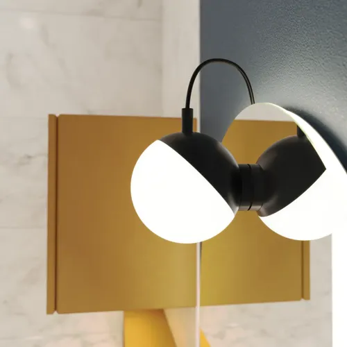 Mirror lamp with soft shapes on a dark blue wall in a stylish bathroom.