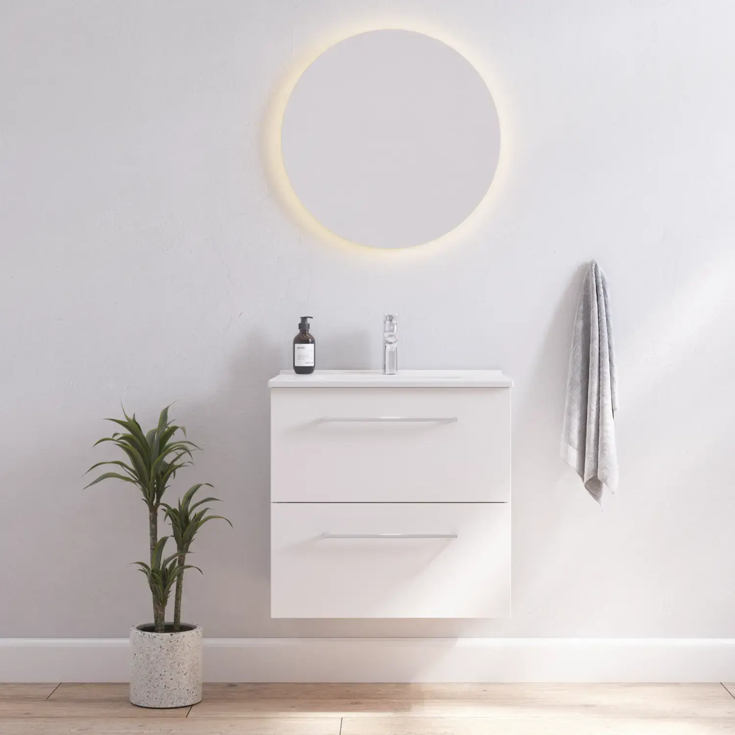 Bathroom inspiration with narrow white vanity unit with white handles and elegant washbasin with beautiful round mirror with light, white walls and wooden floor for a bright and minimalist look.