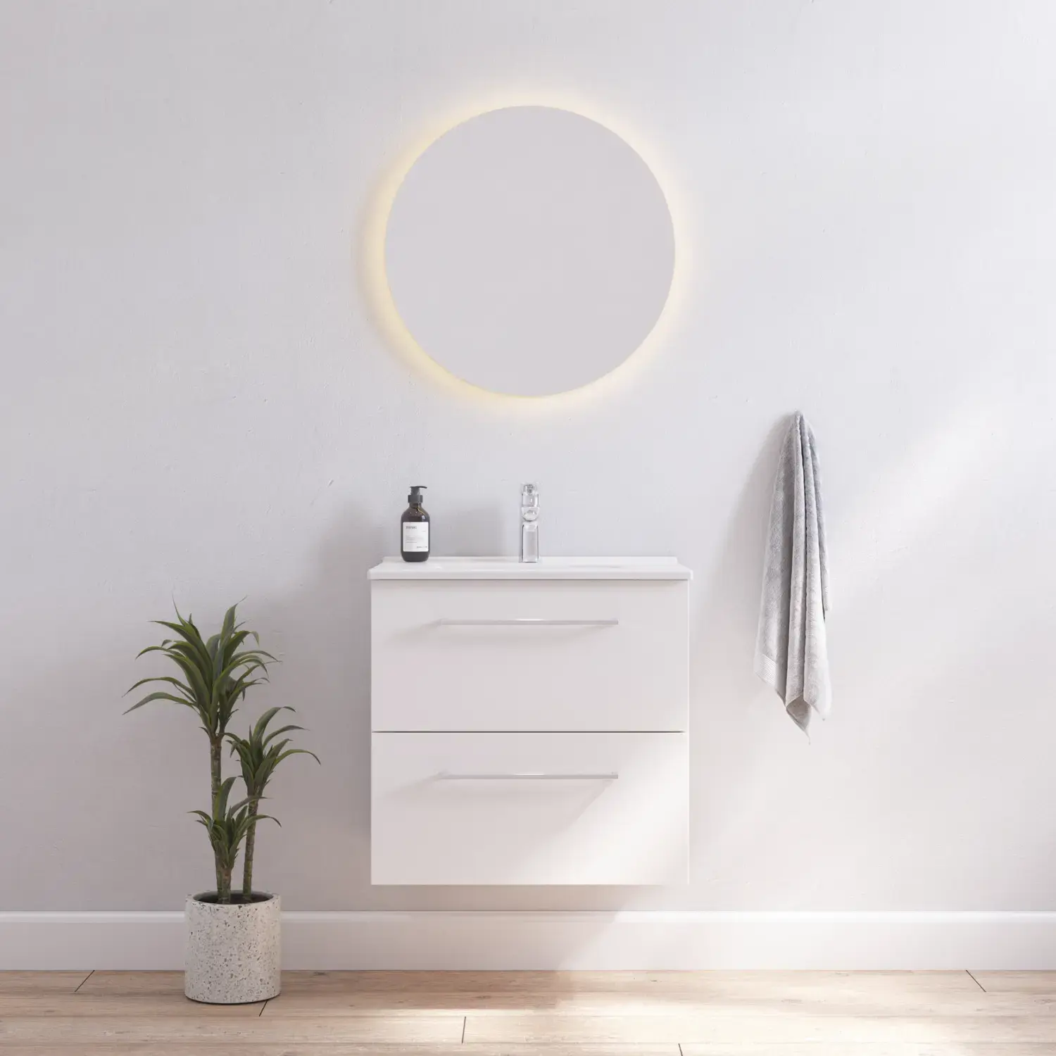 Bathroom inspiration with narrow white vanity unit with white handles and elegant washbasin with beautiful round mirror with light, white walls and wooden floor for a bright and minimalist look.