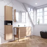 Bathroom inspiration with washbasin cabinets and wall cabinets in light oak with grooves, elegant double sink, beautiful mirror cabinet with light, herringbone floor in light wood, and white marble wall give a classic, bright, and sleek look.