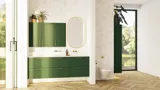 Large bathroom in green colors with vanity unit, brass framed oval mirror and beautiful framed doors