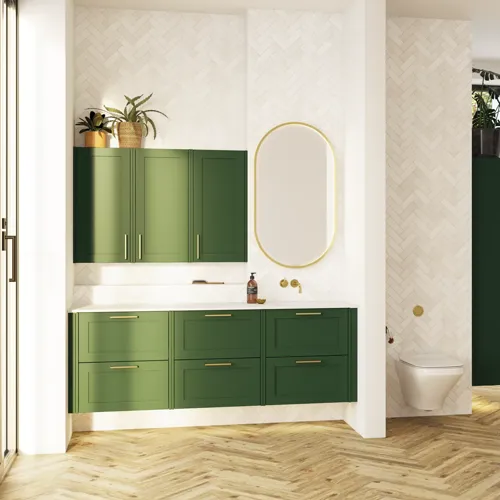 Large bathroom in green colors with vanity unit, brass framed oval mirror and beautiful framed doors